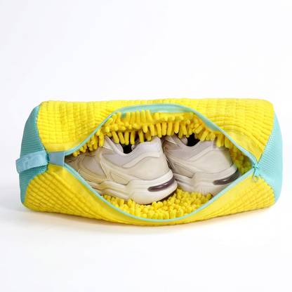Yellow chenille shoe washing bag with aqua zipper, partly open with cream sneakers inside
