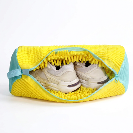Yellow chenille shoe washing bag with aqua zipper, partly open with cream sneakers inside